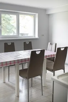 a dining room with a table and chairs at Degučiai ,svečių namai in Šakiai