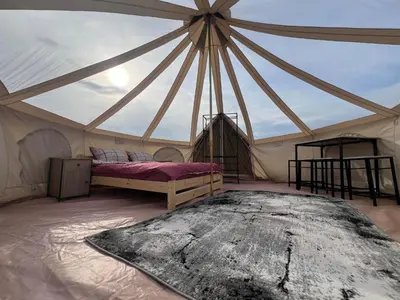 a room with a bed in a tent at Anos Kempingas, Troškūnai in Smėlynė