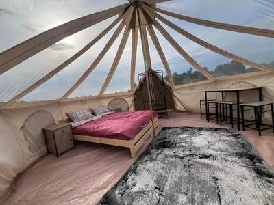 a room with a bed in a tent at Anos Kempingas, Troškūnai in Smėlynė