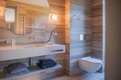 a bathroom with a sink and a toilet and a mirror at Aukštoji Liškiava in Liškiava