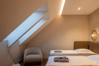 two beds in a room with a attic at Aukštoji Liškiava in Liškiava