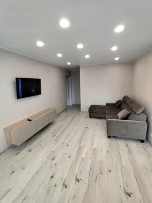 a living room with a couch and a flat screen tv at J&N Hause in Visaginas