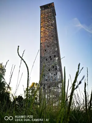 a tall building in the middle of a field at Pušų lašas apartamentai in Birštonas
