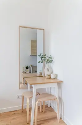 a dining room table with a mirror and stools at Activity & Relax Studio 5 in Druskininkai