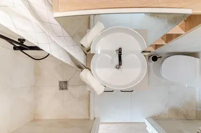 a bathroom with a toilet and a sink at Activity & Relax Studio 5 in Druskininkai