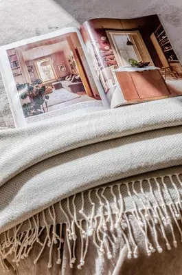 a magazine sitting on top of a bed at Activity & Relax Studio 5 in Druskininkai