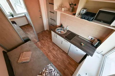 an overhead view of a small kitchen with a sink at Small Studio Apartment in Kaunas