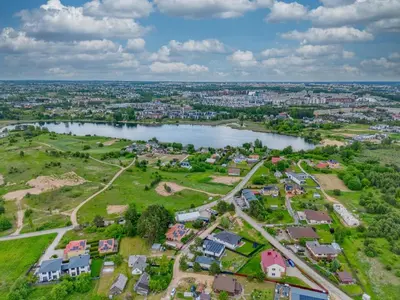 an aerial view of a suburb with a lake at Niwaki Sodai No 1 by URBAN RENT in Vilnius