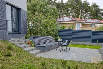 a patio with a table and chairs in a yard at Niwaki Sodai No 1 by URBAN RENT in Vilnius