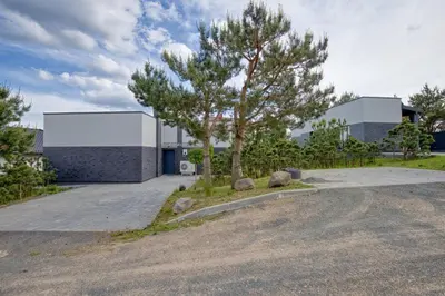 a tree in front of a building with a building at Niwaki Sodai No 1 by URBAN RENT in Vilnius