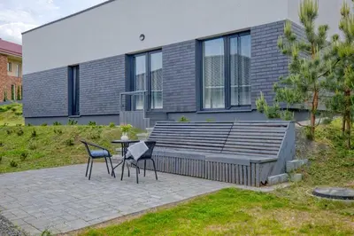 two chairs and a table in front of a house at Niwaki Sodai No 1 by URBAN RENT in Vilnius