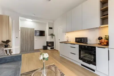 a kitchen with white cabinets and a stove at Niwaki Sodai No 1 by URBAN RENT in Vilnius