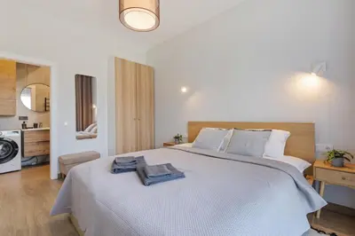 a bedroom with a large white bed with towels on it at Niwaki Sodai No 1 by URBAN RENT in Vilnius