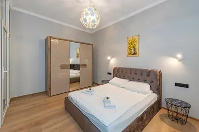 a bedroom with a bed and a large mirror at The Comfort Apartment #2 by Polo Apartments in Kaunas