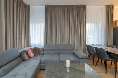 a living room with a couch and a table at The Comfort Apartment #2 by Polo Apartments in Kaunas