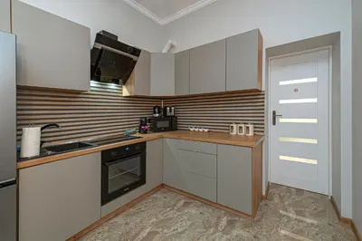 a kitchen with white cabinets and a stove top oven at The Comfort Apartment #2 by Polo Apartments in Kaunas