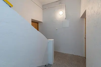 a hallway with a white wall and a door at The Comfort Apartment #2 by Polo Apartments in Kaunas