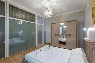 a bedroom with a bed and a large mirror at The Comfort Apartment #2 by Polo Apartments in Kaunas