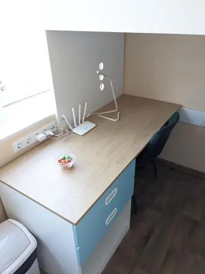 a desk in an office with a bowl of fruit on it at Tiny Studio Apartment in Kaunas