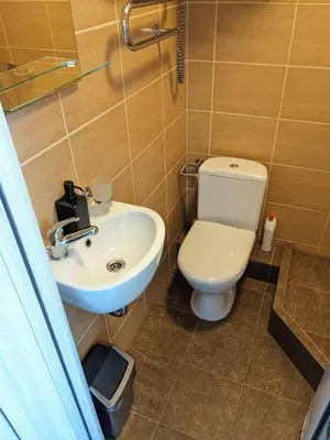 a bathroom with a toilet and a sink at Tiny Studio Apartment in Kaunas