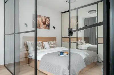 a bedroom with two beds and a mirror at Central Location I Private Garage Parking & Easy Checkin I Cᴏʜᴏsᴛ in Vilnius