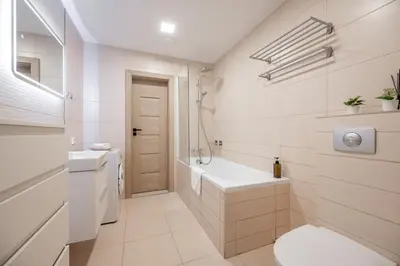 a white bathroom with a tub and a sink at Central Location I Private Garage Parking & Easy Checkin I Cᴏʜᴏsᴛ in Vilnius