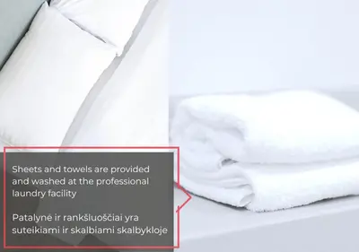 a pile of towels sitting on top of a bed at Central Location I Private Garage Parking & Easy Checkin I Cᴏʜᴏsᴛ in Vilnius