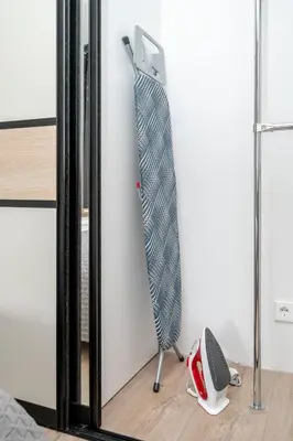 a tie hanging on a wall next to a mirror at Central Location I Private Garage Parking & Easy Checkin I Cᴏʜᴏsᴛ in Vilnius