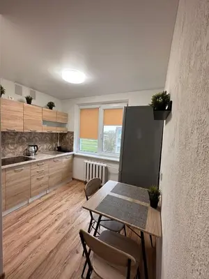 a kitchen with a table and chairs in a room at MB BENO TRUMPALAIKE NUOMA BUTUKAs in Kėdainiai