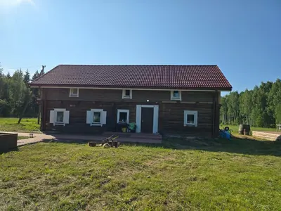 a small house in a field next to a yard at Draugų sodyba
