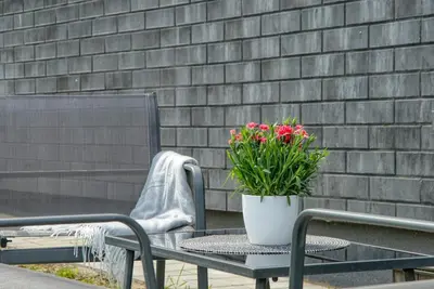 a patio table with a potted plant on it at Niwaki Sodai No 2 by URBAN RENT in Vilnius
