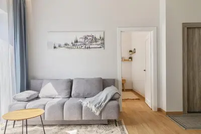 a living room with a couch and a table at Niwaki Sodai No 3 by URBAN RENT in Vilnius