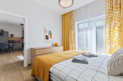 a bedroom with a bed and a large window at Niwaki Sodai No 3 by URBAN RENT in Vilnius
