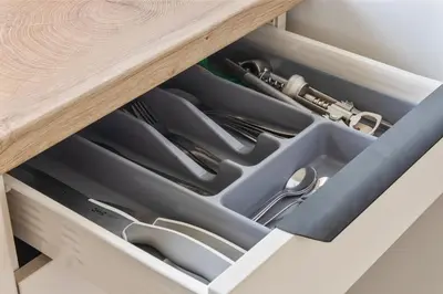 a drawer in a wooden table with utensils at Niwaki Sodai No 3 by URBAN RENT in Vilnius
