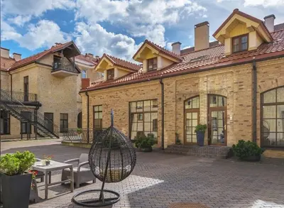 an exterior view of a building with a patio at Spacious Townhouse in The Heart of Vilnius Old Town in Vilnius
