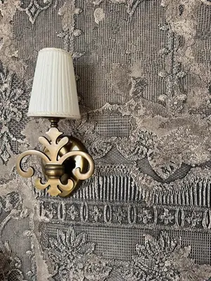 a lamp on a wall with a lamp on it at Spacious Townhouse in The Heart of Vilnius Old Town in Vilnius