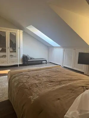 a bedroom with a large bed and a couch at Spacious Townhouse in The Heart of Vilnius Old Town in Vilnius