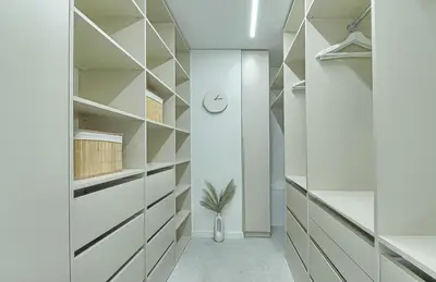 a walk in closet with white walls and shelves at Premium apartment x free parking x 24x7 in Vilnius