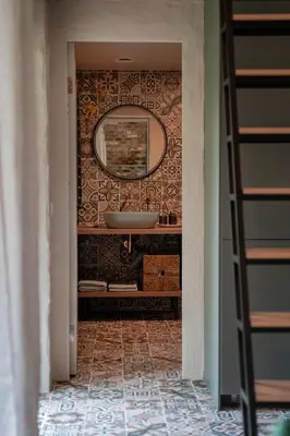 a bathroom with a sink and a mirror on a wall at Pramogų namelis