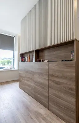 a large wooden cabinet in a room with a window at Vincent Urban Nest - Near Clinic, Arena and Stadium in Kaunas