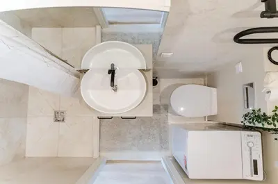 a bathroom with a sink and a toilet at Nemunas A respite Studio 8 in Druskininkai