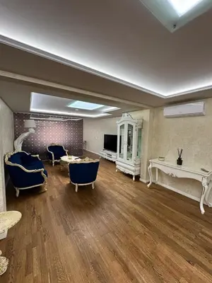 a large living room with blue chairs and a table at Classic Style Apartment in Kelmė