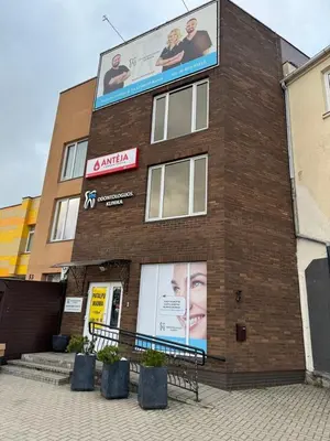 a building with a large advertisement on the side of it at Classic Style Apartment in Kelmė