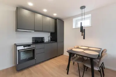 a kitchen with a table and a dining room at Panorama City View Apartment in Vilnius