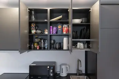 a kitchen with a counter top with a microwave at Panorama City View Apartment in Vilnius
