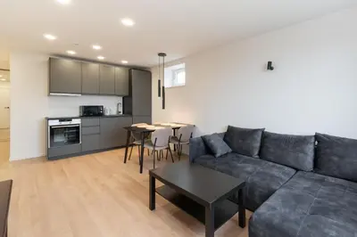 a living room with a couch and a table at Panorama City View Apartment in Vilnius