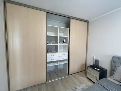 a bedroom with a sliding glass door at Dani apartment in Panevėžys