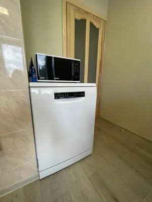 a microwave sitting on top of a refrigerator at Dani apartment in Panevėžys