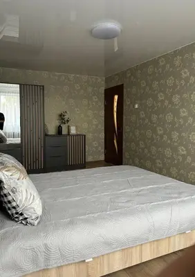 a bedroom with a large bed in a room at MB BENO TRUMPALAIKE NUOMA LUKSIUKAs in Kėdainiai