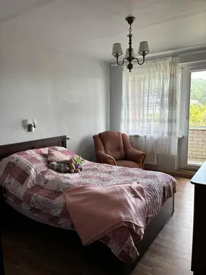 a bedroom with a bed with a stuffed animal on it at Ramybės kotedžas in Kaunas